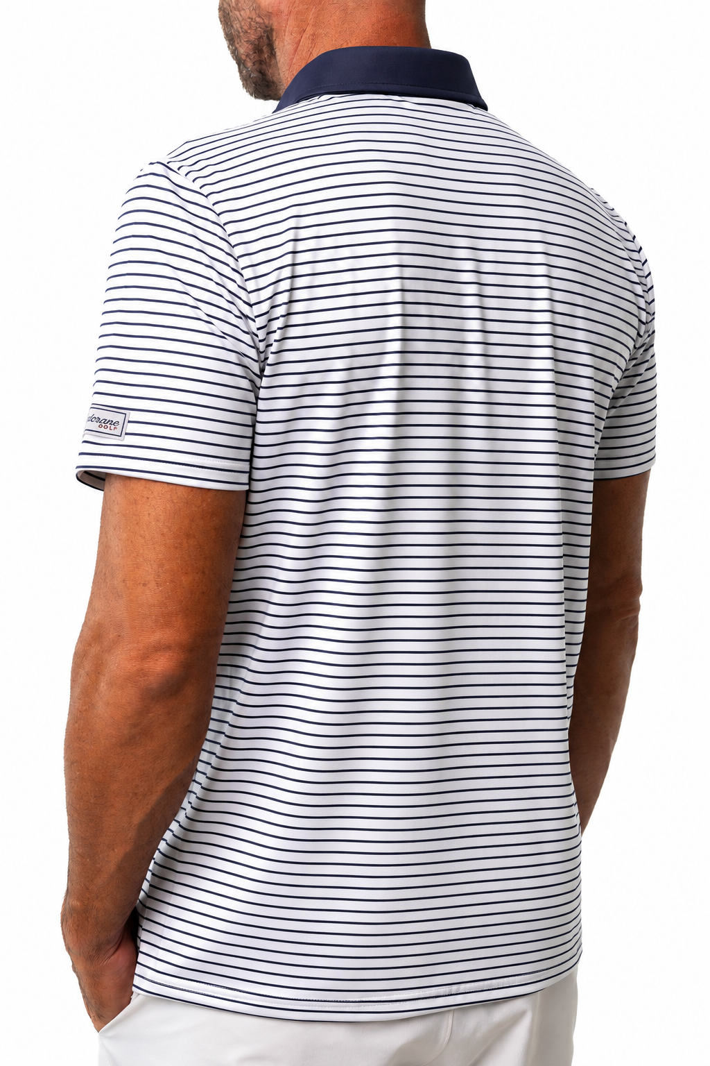 A man viewed from the back wearing a white short-sleeve polo shirt with thin navy horizontal stripes and a solid navy collar.